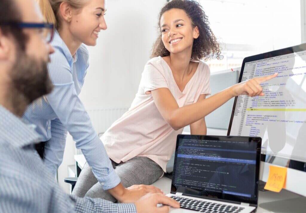 woman pointing to information on a computer monitor