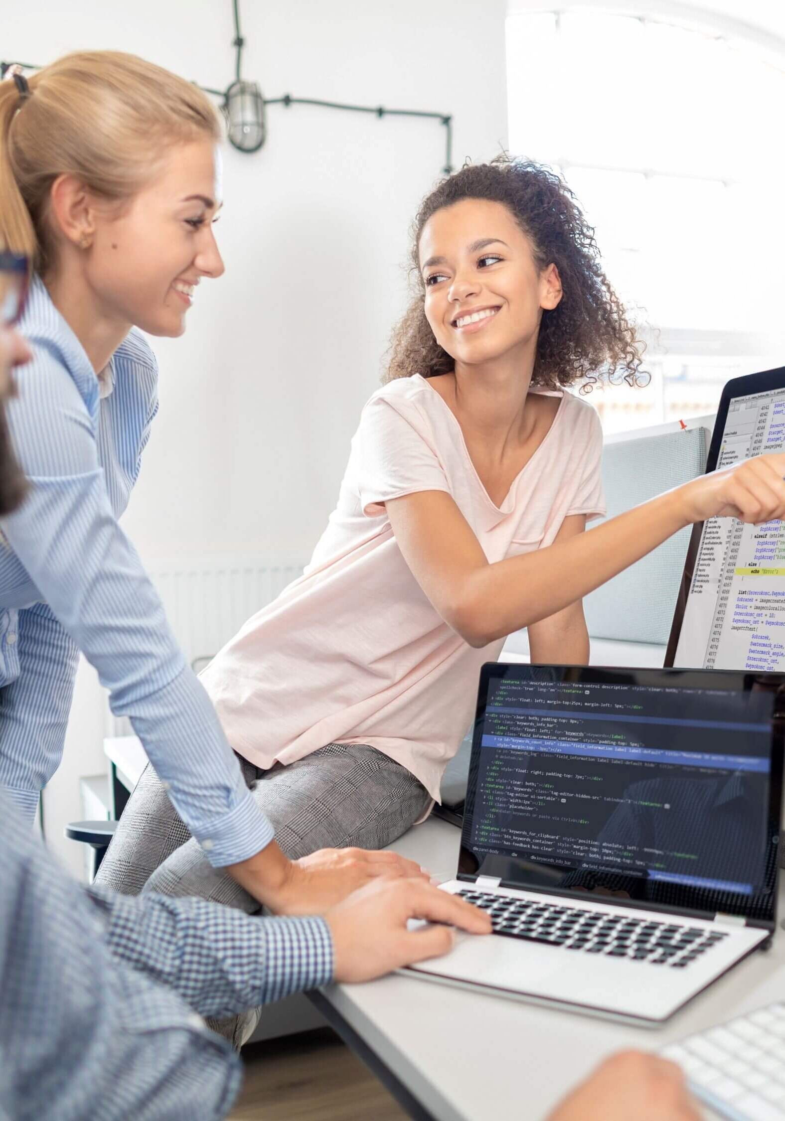 woman pointing to information on a computer monitor